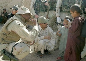 American Soldier with Afghani Children Learning to brush teeth in Afghanistan.